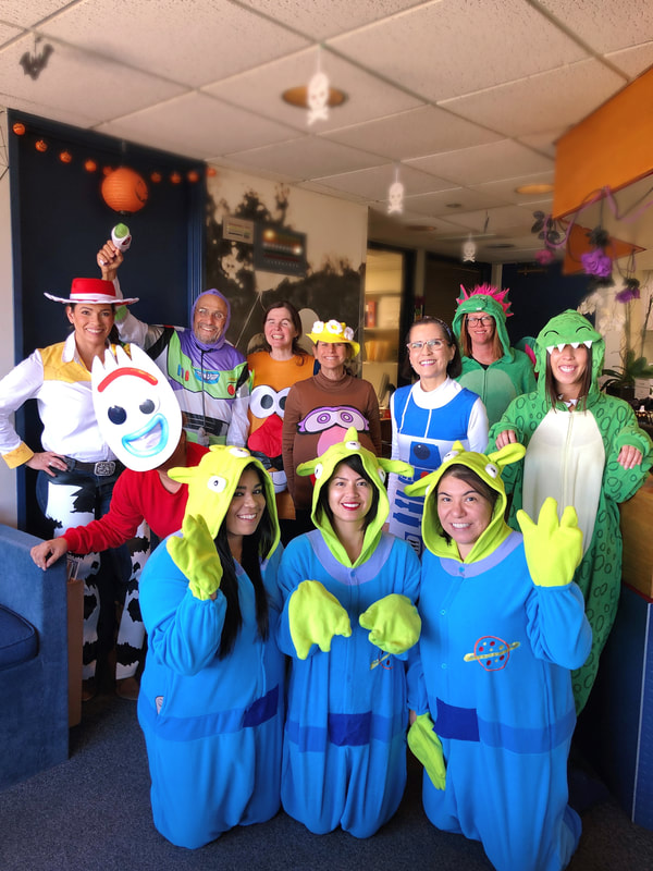 Group photo of staff in Toy Story Halloween costumes
